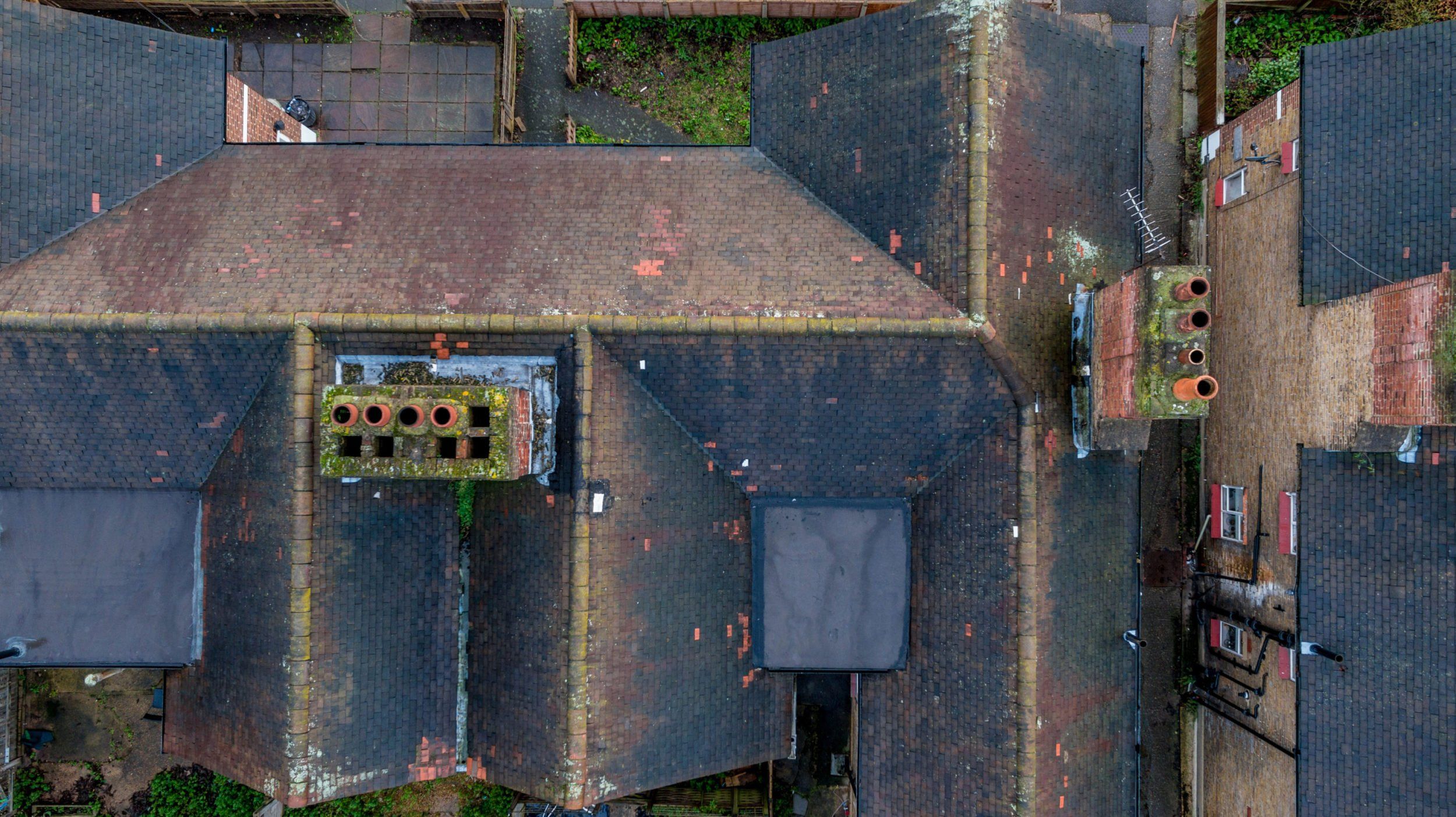 Drone flying over a UK residential property for aerial roof and chimney inspection